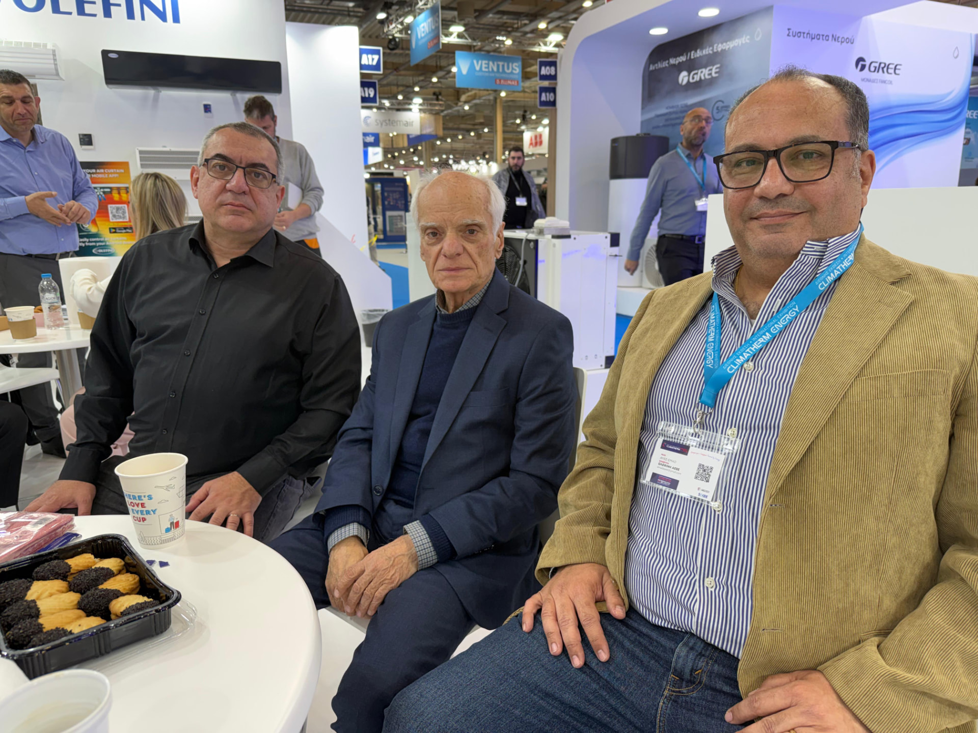Omega and Olefini teams together at the Olefini stand in Athens, Greece